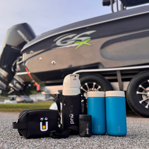 Premium pnümix Captain’s Edition kit including portable cocktail mixer, blue stainless steel tumblers, travel sling, accessory pouch, and magazine case. Ideal for captains, boaters, and outdoor explorers seeking leakproof, floatable drinkware for custom drinks on the water, at the dock, or while camping—ready for every adventure, no premade beverages required.