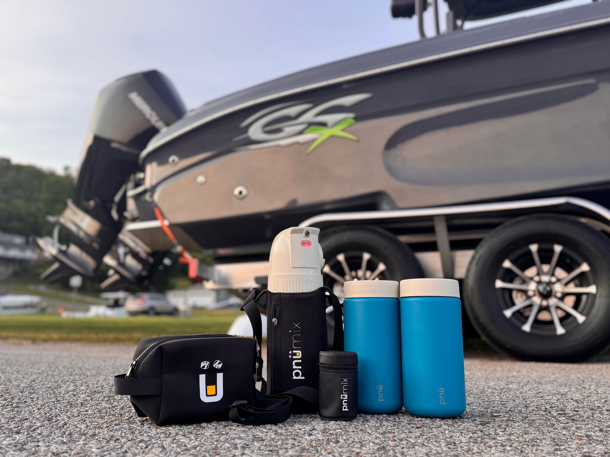Premium pnümix Captain’s Edition kit including portable cocktail mixer, blue stainless steel tumblers, travel sling, accessory pouch, and magazine case. Ideal for captains, boaters, and outdoor explorers seeking leakproof, floatable drinkware for custom drinks on the water, at the dock, or while camping—ready for every adventure, no premade beverages required.
